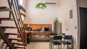 a kitchen with a table and chairs and a refrigerator at Toucan Villa Rio Cuarto in Río Cuarto