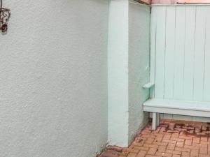 a white building with a bench next to a window at Whitby Sands in Whitby