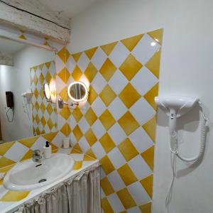 a bathroom with a sink and a mirror at Le Cocon des Trois Marmottes in Saillans +16 photos