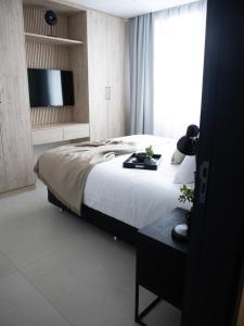 Postel nebo postele na pokoji v ubytování Divina Tower Apart Hotel