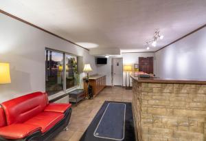 a living room with a red couch and a bar at Pigeon Forge Parkway Inn in Pigeon Forge