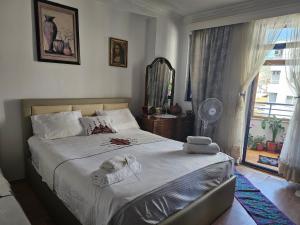 a bedroom with a white dog laying on a bed at Apartament Karafili in Pogradec