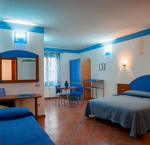 a hotel room with two beds and a table at Sogni Nel Blu in Ustica
