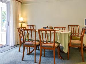 a dining room with a table and chairs at Heather Cottage in Saint Erth