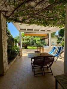 a patio with a table and chairs under a pavilion at Villa Giulia in Parghelia