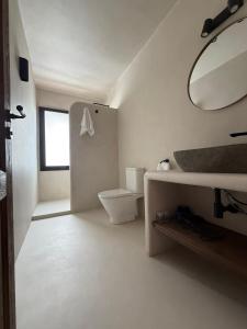 a white bathroom with a toilet and a mirror at Casa Bel - Apartment 2 in Miami Platja +22 photos