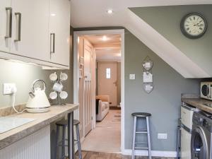 a kitchen with a counter and stools in a room at Middle Cottage in York