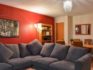 a living room with a couch and a red wall at The Retreat in Whitby