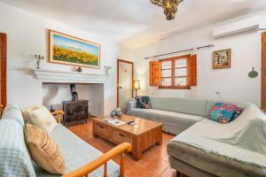 a living room with two couches and a fireplace at Casa Jaïra Sierra de Castril in Castril