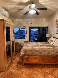 a bedroom with a bed and a ceiling fan at The House of Angels in Las Conchas