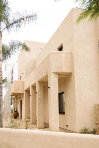 a building with palm trees in front of it at Casa Bel - Apartment 3 in Miami Platja +13 photos