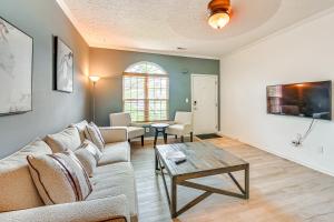 a living room with a couch and a table at 10 Mi to Keeneland Family Home with Deck and Yard in Lexington