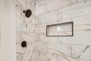 a bathroom with a marble shower with a window at 10 Mi to Keeneland Family Home with Deck and Yard in Lexington +16 photos
