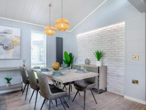 a dining room with a table and chairs at Three Sandbanks in Benllech