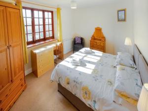 a bedroom with a bed and a window at Latrigg View - Uk45177 in Threlkeld