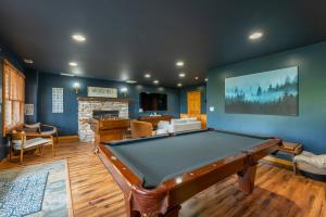 a living room with a pool table and a fireplace at Whiskey Hills - Newly Remodeled Luxury Cabin with Hot Tub, Incredible Views close to Asheville, walk to Hatley Pointe & Ski! in Swiss +42 photos