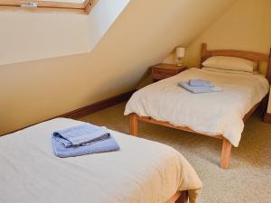 a room with two beds with towels on them at Rose Cottage - 30502 in West Firle