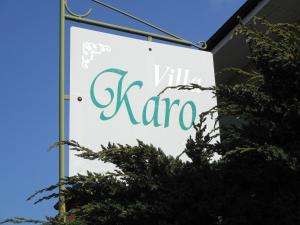 a sign for a zara store with trees in the foreground at Villa Karo in Łeba