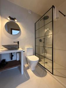 a bathroom with a toilet and a sink and a shower at Casa Bel - Apartment 5 in Miami Platja +14 photos