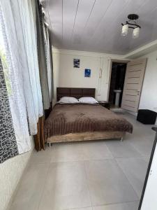 a bedroom with a large bed in a room at Green House მწვანე სახლი in Sighnaghi