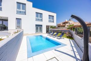a swimming pool in the backyard of a house at Peninsula Villas in Premantura
