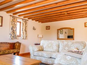 a living room with a couch and a table at The Milking Parlour in Tutbury