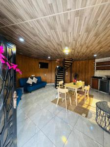 a living room with a table and a blue couch at Neverland Resort مزرعة نيفرلاند in Irbid +75 photos