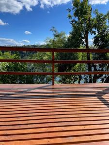 a wooden bench on top of a boardwalk at Cabañas del Mirador in Puerto Iguazú