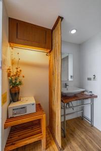 a bathroom with a sink and a counter with a table at Sunset Serenity Jomtien Resort in Na Jomtien