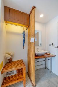 a bathroom with a sink and a wooden counter at Sunset Serenity Jomtien Resort in Na Jomtien
