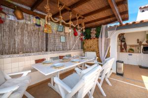 a dining room with a table and chairs at Vila da Encosta - Private - Heated swimming pool - By bedzy in Albufeira