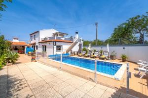 a swimming pool in front of a house at Vila da Encosta - Private - Heated swimming pool - By bedzy in Albufeira