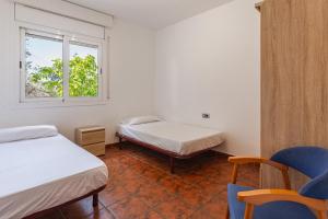 a room with two beds and a window at Villa Roselles in Lloret de Mar +33 photos