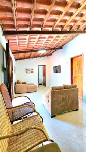 a living room with two couches and a couch at Casa com piscina em Guaramiranga - Chalé Verdelândia in Guaramiranga