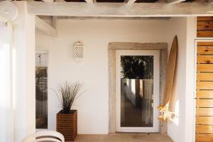 a mirror on a wall next to a door at Sea'Ya Thoughtful Stays - Villas in Cascais