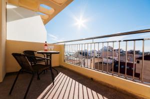 
a dining room with a bench and a balcony at Hotel Fontana Plaza in Torrevieja
