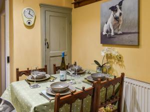 a dining room table with a dog on the wall at Home Cottage in Hovingham