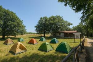 a group of tents in a field next to a building at Le Chiancate in San Giovanni Rotondo