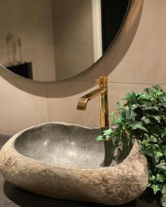 a stone sink with a faucet in a bathroom at House of Ellie 2 in Tromsø