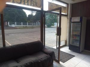 a couch sitting outside of a store with a window at Hotel Pensión Galicia in Obaldía +46 photos