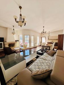 a living room with a couch and a glass table at Villa RELAX Miševići in Sarajevo +84 photos