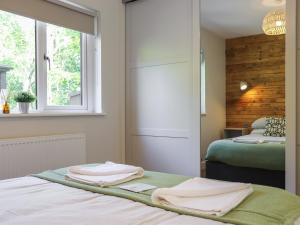 a bedroom with a bed with towels on it at Dinas Lodge - Uk47607 in Caernarfon