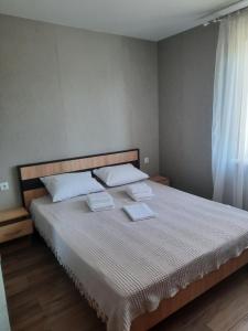 a bedroom with a bed with two towels on it at Solmaris in Odesa +24 photos