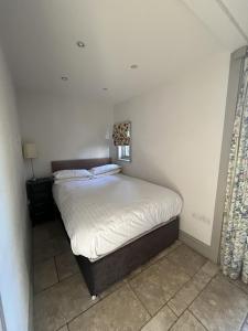 a bedroom with a large bed with white sheets at Thornton Manor Estate in Wirral +22 photos
