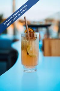 a drink sitting on a table with aigger in it at Hôtel Les Voiles in Toulon