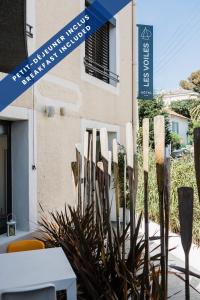 a group of wooden sticks in front of a building at Hôtel Les Voiles in Toulon +36 photos