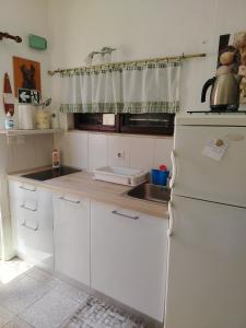 a kitchen with a white refrigerator and a sink at Apartman Karla in Makarska +21 photos