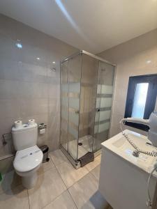 a bathroom with a shower and a toilet and a sink at Santjordi by Confortsky in Pas de la Casa