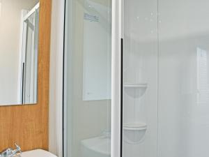 a bathroom with a shower and a toilet and a sink at Ocean Edge in Heysham +12 photos