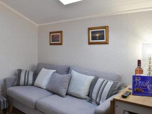 a living room with a gray couch with pillows at Cuillin View Apartment - Uk12529 in Arisaig